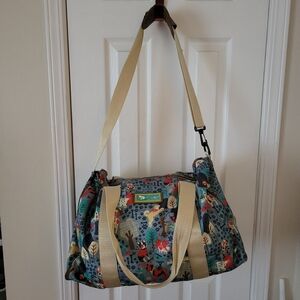 Lily Bloom duffel bag with a whimsical dog-themed pattern.